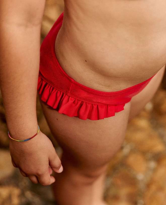Sun protective bikini bottom with ruffles Romy in Cranberry red