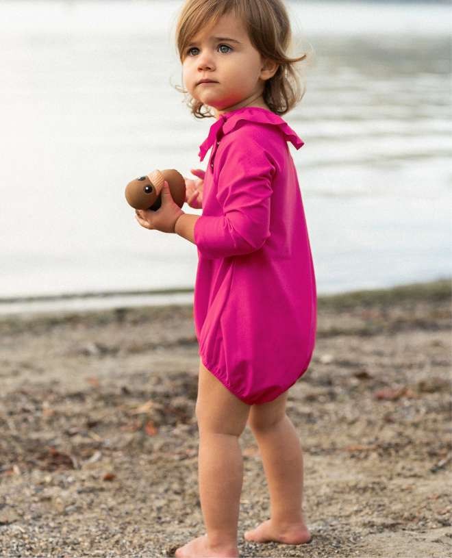 Long sleeve baby sun protective swimsuit in Fuschia pink by Canopea