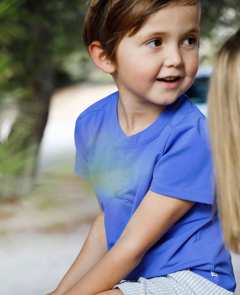 Boy wearing an Indigo blue sun protective rashguard  by Canopea